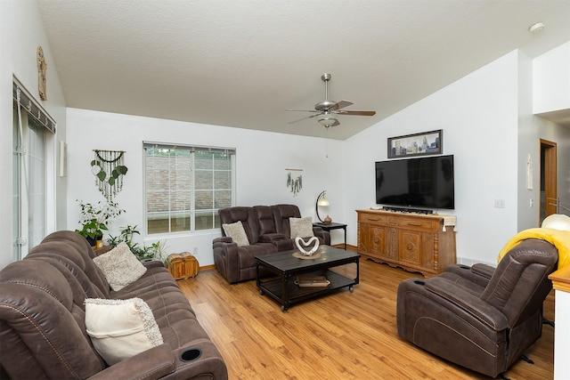3540 E University Ave, Des Moines, IA 50317 - living room featuring ceiling fan, vaulted ceiling, and light wood finished floors