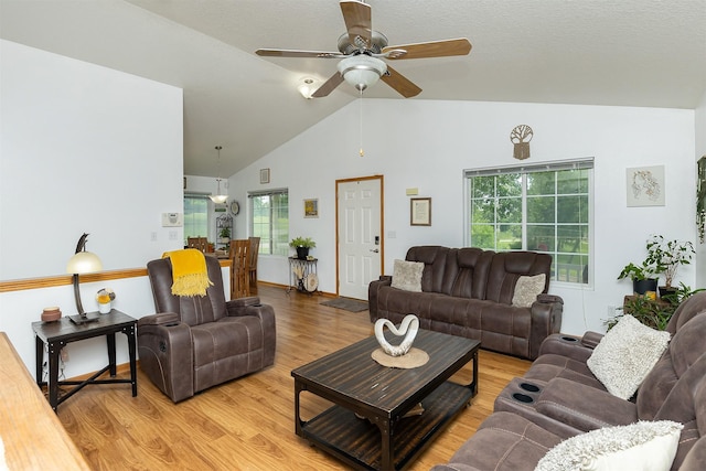 3540 E University Ave, Des Moines, IA 50317 - living room with light wood finished floors, a ceiling fan, and high vaulted ceiling