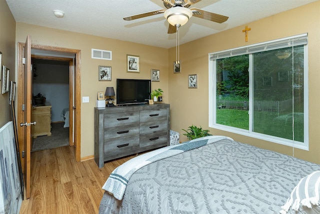 3540 E University Ave, Des Moines, IA 50317 - bedroom with light wood finished floors and a ceiling fan