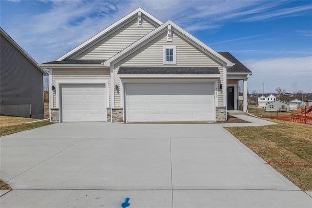5610 Leyden Ave, Des Moines, IA 50317 - view of front of home with stone siding, driveway, a garage, and a shingled roof