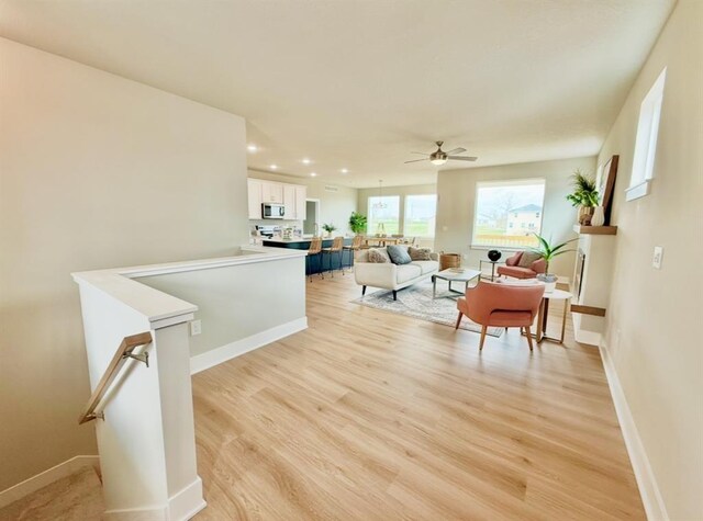 5610 Leyden Ave, Des Moines, IA 50317 - living area featuring light wood-style flooring, ceiling fan, and recessed lighting