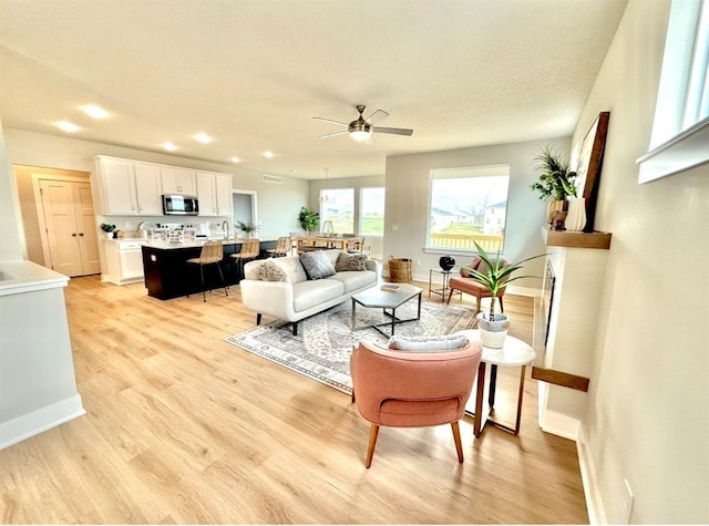 5610 Leyden Ave, Des Moines, IA 50317 - living area with light wood-style floors, ceiling fan, and recessed lighting