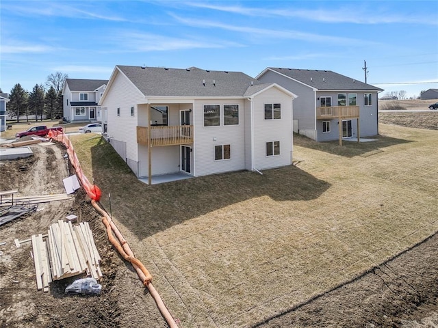 5610 Leyden Ave, Des Moines, IA 50317 - rear view of property with a balcony, a yard, and a patio area
