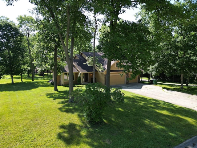 6020 NE 9th St, Des Moines, IA 50313 - view of property hidden behind natural elements featuring an attached garage, concrete driveway, and a front lawn