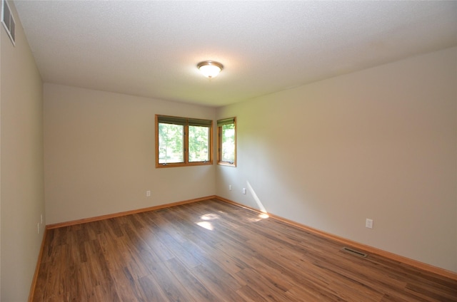 6020 NE 9th St, Des Moines, IA 50313 - unfurnished room featuring wood finished floors and baseboards