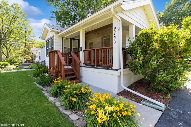 2730 53rd St, Des Moines, IA 50310 - view of home's exterior featuring a yard, covered porch, and roof with shingles
