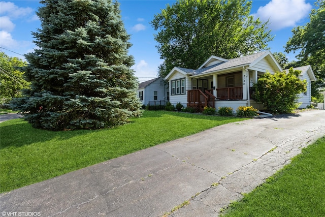 2730 53rd St, Des Moines, IA 50310 - view of front facade with a porch, a front yard, and roof with shingles