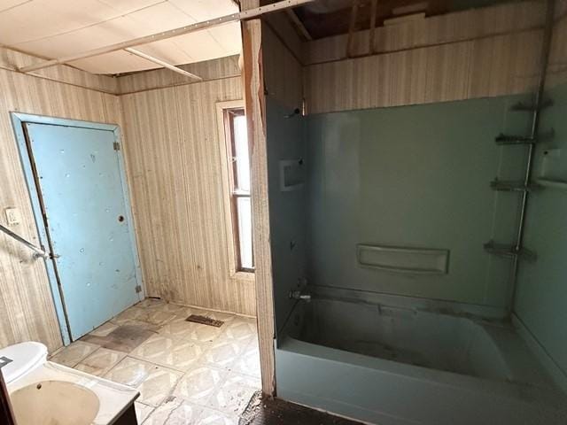 603 N 1st Ave, Marshalltown, IA 50158 - bathroom with wood walls, shower / washtub combination, vanity, and tile patterned floors