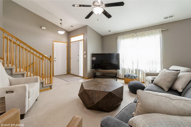 200 Walnut Dr NW, Bondurant, IA 50035 - living area featuring lofted ceiling, a ceiling fan, light carpet, and stairs