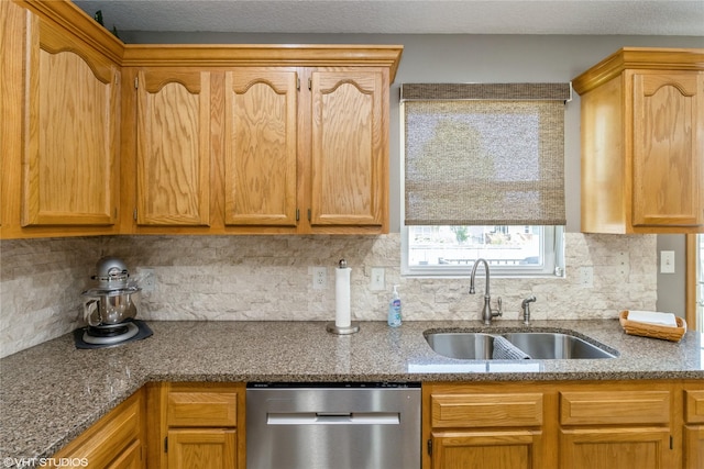 200 Walnut Dr NW, Bondurant, IA 50035 - kitchen featuring stainless steel dishwasher, tasteful backsplash, and dark stone countertops
