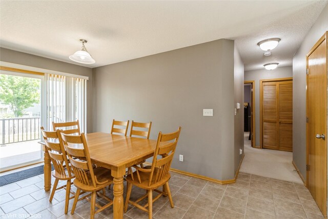 200 Walnut Dr NW, Bondurant, IA 50035 - dining space featuring a textured ceiling and light tile patterned floors