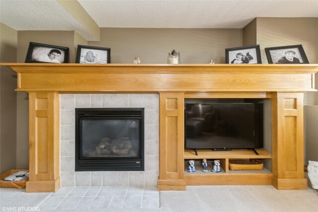 200 Walnut Dr NW, Bondurant, IA 50035 - detailed view of carpet floors, a tile fireplace, and a textured ceiling
