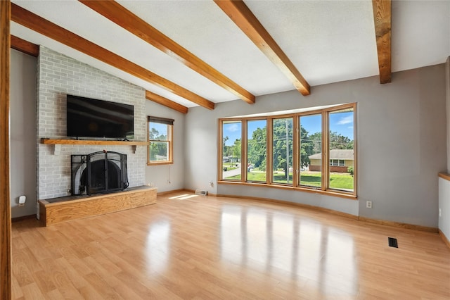 6843 NW 5th St, Des Moines, IA 50313 - unfurnished living room with healthy amount of natural light, a fireplace, and wood finished floors