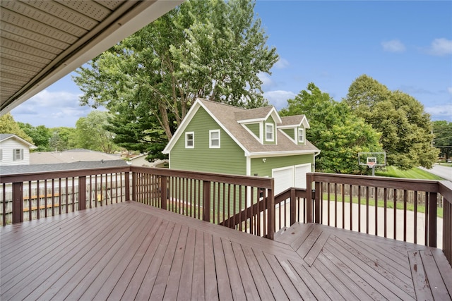 6843 NW 5th St, Des Moines, IA 50313 - wooden terrace with a detached garage and view of wooded area