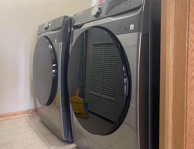 2101 Meadow Ct Unit 304, Des Moines, IA 50320 - laundry room with light tile patterned flooring and washer and dryer