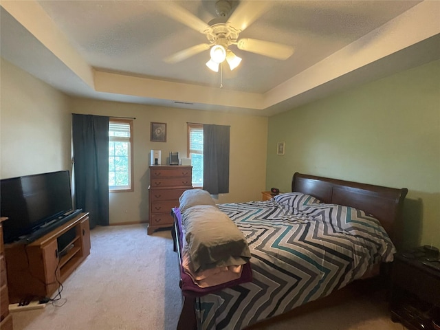 2101 Meadow Ct Unit 304, Des Moines, IA 50320 - bedroom with light colored carpet, a tray ceiling, and ceiling fan