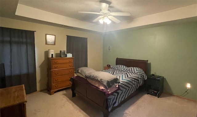 2101 Meadow Ct Unit 304, Des Moines, IA 50320 - bedroom with light carpet, a ceiling fan, and a raised ceiling