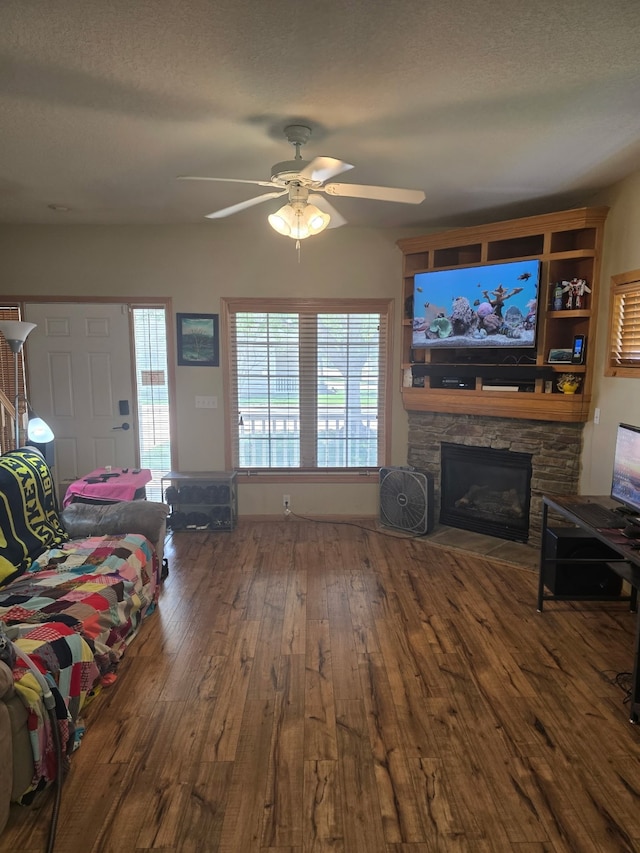 2101 Meadow Ct Unit 304, Des Moines, IA 50320 - living area with a ceiling fan, wood-type flooring, a fireplace, and a textured ceiling