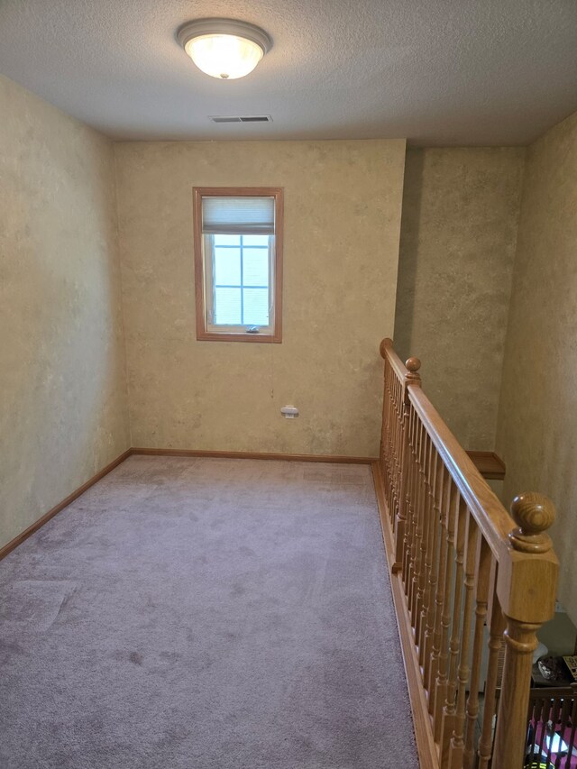 2101 Meadow Ct Unit 304, Des Moines, IA 50320 - carpeted spare room featuring a textured ceiling and baseboards