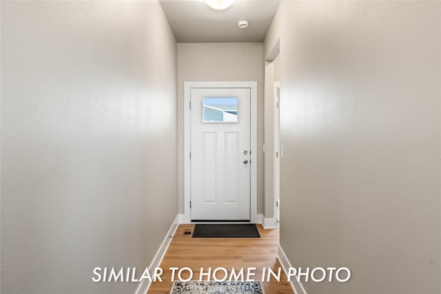 1488 S 91st St, West Des Moines, IA 50266 - doorway with baseboards and light wood-style flooring