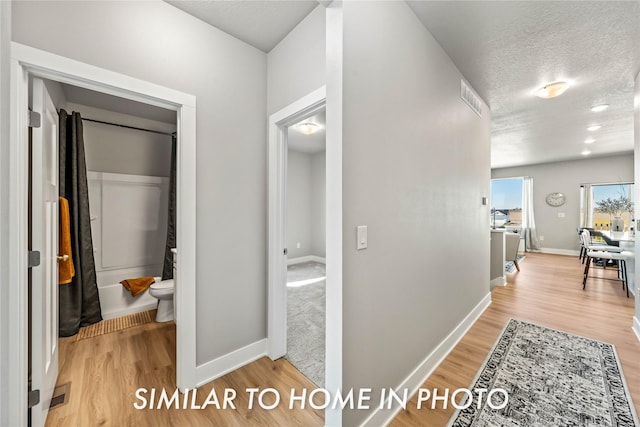 1488 S 91st St, West Des Moines, IA 50266 - hall featuring light wood finished floors and a textured ceiling