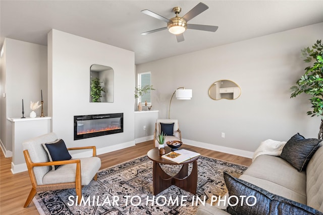 1488 S 91st St, West Des Moines, IA 50266 - living area featuring ceiling fan, wood finished floors, and a glass covered fireplace