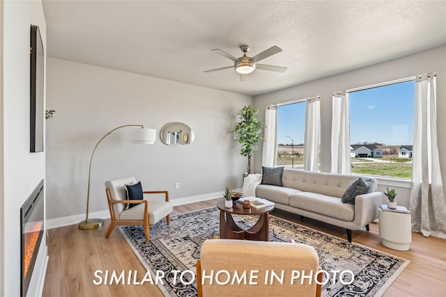 1488 S 91st St, West Des Moines, IA 50266 - living room featuring a ceiling fan and light wood finished floors