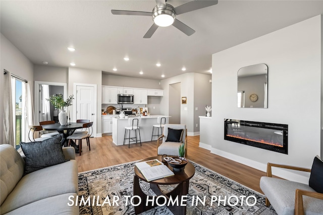 1488 S 91st St, West Des Moines, IA 50266 - living area with recessed lighting, light wood-type flooring, ceiling fan, and a glass covered fireplace