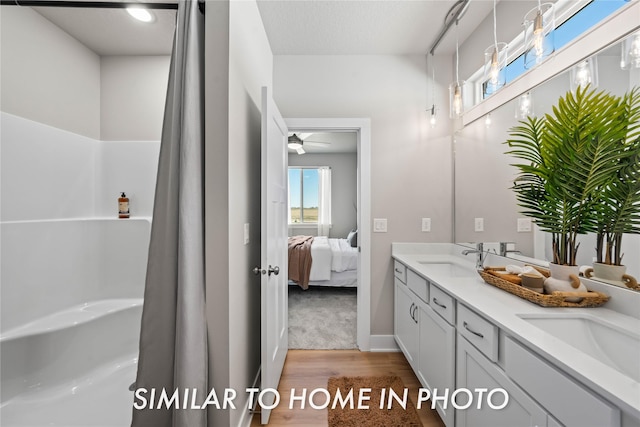 1488 S 91st St, West Des Moines, IA 50266 - bathroom featuring wood finished floors, double vanity, ensuite bathroom, and a ceiling fan