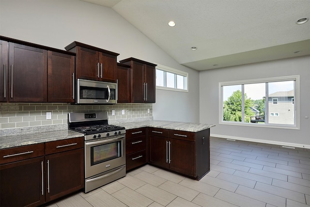9305 Sugar Creek Cir, West Des Moines, IA 50266 - kitchen featuring stainless steel appliances, tasteful backsplash, vaulted ceiling, a peninsula, and light stone counters