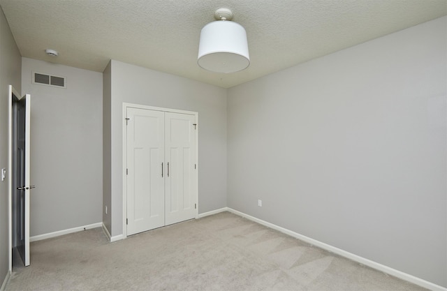 9305 Sugar Creek Cir, West Des Moines, IA 50266 - unfurnished bedroom with carpet floors, a closet, and a textured ceiling