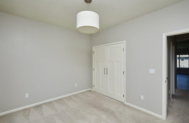 9305 Sugar Creek Cir, West Des Moines, IA 50266 - unfurnished bedroom with light colored carpet, a closet, and a textured ceiling