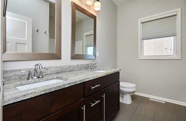 9305 Sugar Creek Cir, West Des Moines, IA 50266 - bathroom with toilet and double vanity