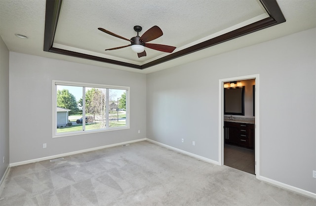 9305 Sugar Creek Cir, West Des Moines, IA 50266 - unfurnished bedroom featuring a tray ceiling, carpet flooring, a textured ceiling, connected bathroom, and ceiling fan