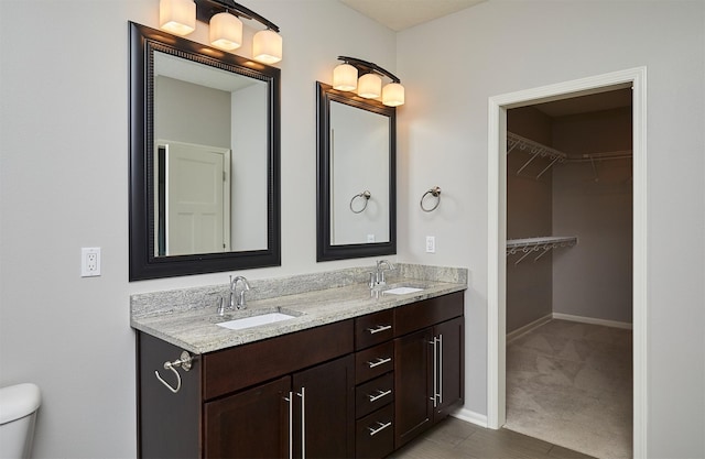 9305 Sugar Creek Cir, West Des Moines, IA 50266 - bathroom with double vanity and a walk in closet