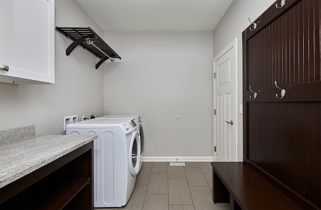 9305 Sugar Creek Cir, West Des Moines, IA 50266 - laundry area with cabinet space and washer and clothes dryer