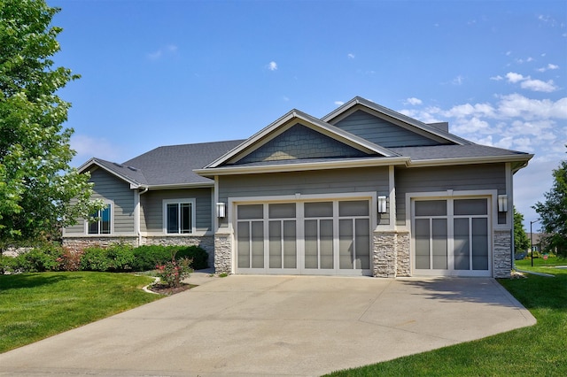9305 Sugar Creek Cir, West Des Moines, IA 50266 - craftsman house with stone siding, driveway, a front lawn, and a garage