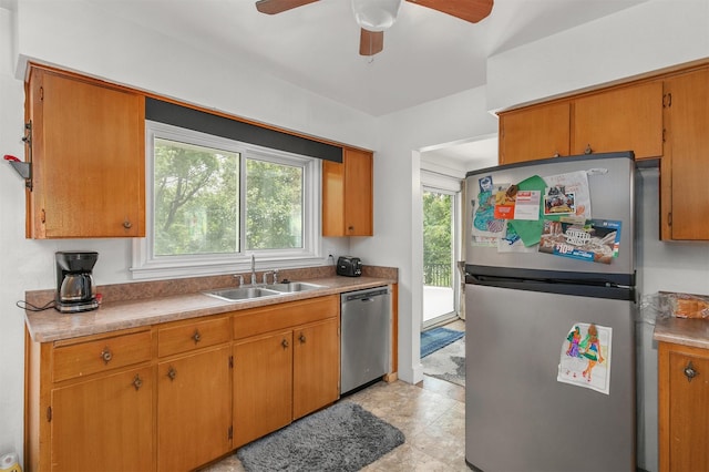 2904 Shadyoak Dr, Des Moines, IA 50310 - kitchen featuring appliances with stainless steel finishes, ceiling fan, brown cabinetry, and light countertops