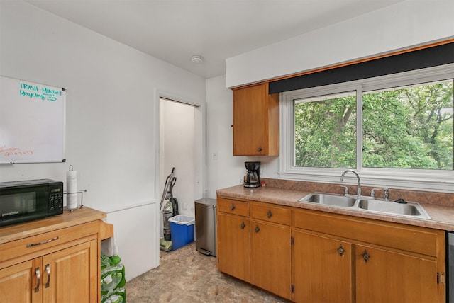 2904 Shadyoak Dr, Des Moines, IA 50310 - kitchen featuring black microwave, light countertops, and brown cabinetry