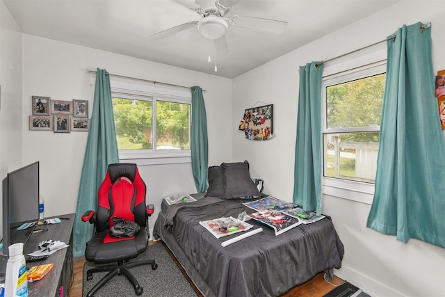 2904 Shadyoak Dr, Des Moines, IA 50310 - bedroom with multiple windows, ceiling fan, and wood finished floors