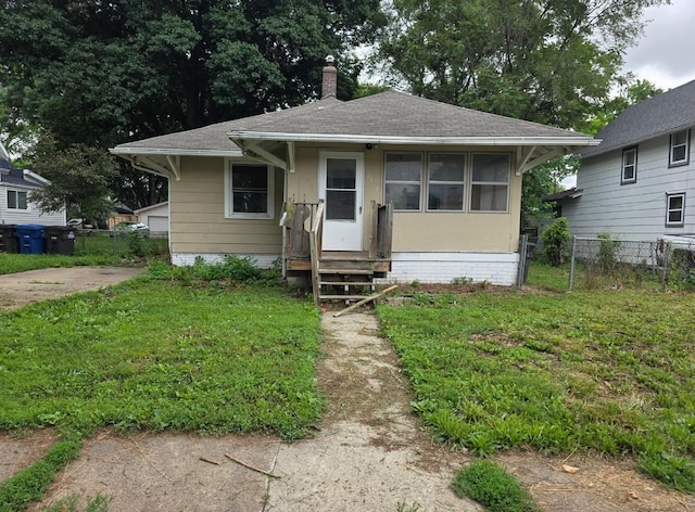 2127 E 13th St, Des Moines, IA 50316 - bungalow-style house with roof with shingles, a chimney, and entry steps