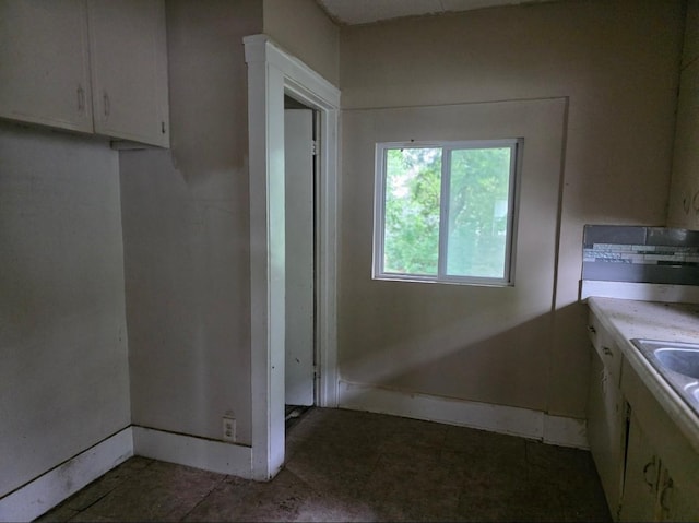 2127 E 13th St, Des Moines, IA 50316 - kitchen featuring light countertops and white cabinetry