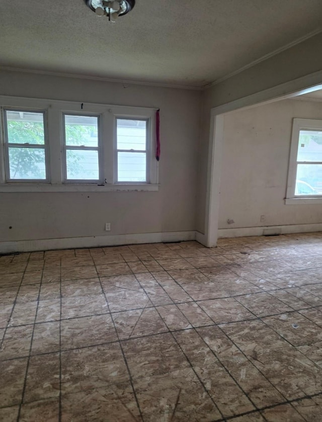 2127 E 13th St, Des Moines, IA 50316 - empty room featuring plenty of natural light, crown molding, and a textured ceiling