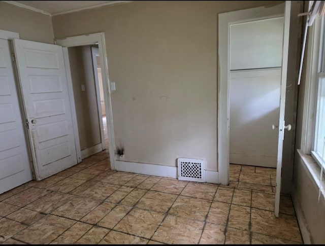2127 E 13th St, Des Moines, IA 50316 - unfurnished bedroom featuring crown molding