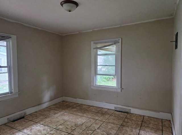 2127 E 13th St, Des Moines, IA 50316 - spare room with healthy amount of natural light and crown molding