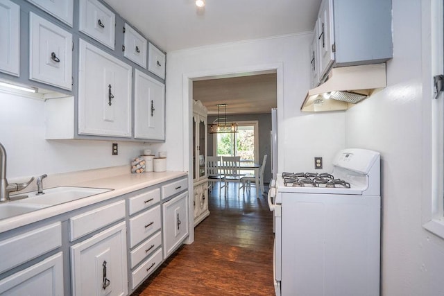 310 E 19th St S, Newton, IA 50208 - kitchen with white gas range, range hood, dark wood finished floors, light countertops, and white cabinets