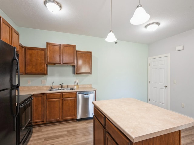 1825 SW White Birch Cir Unit 10, Ankeny, IA 50023 - kitchen with black appliances, light wood-style flooring, light countertops, and decorative light fixtures