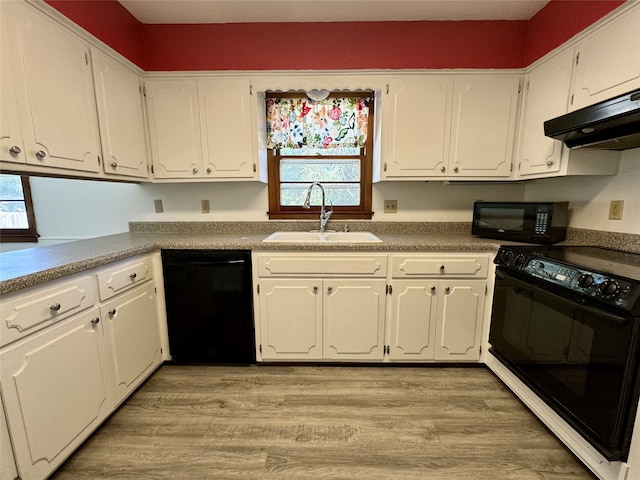 4425 Amick Ave, Des Moines, IA 50310 - kitchen with black appliances, under cabinet range hood, and white cabinets