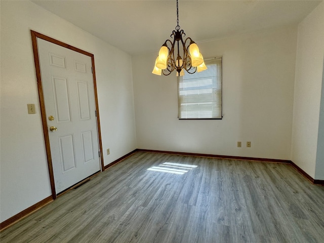 4425 Amick Ave, Des Moines, IA 50310 - spare room featuring a chandelier and wood finished floors