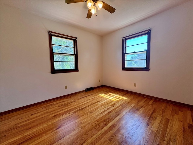 4425 Amick Ave, Des Moines, IA 50310 - unfurnished room with healthy amount of natural light, light wood-type flooring, and ceiling fan